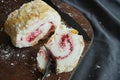 Meringue roll with raspberry jam and almonds on a wooden board Royalty Free Stock Photo