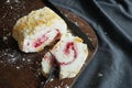 Meringue roll with raspberry jam and almonds on a wooden board Royalty Free Stock Photo