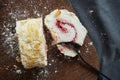 Meringue roll with raspberry jam and almonds on a wooden board Royalty Free Stock Photo