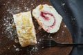 Meringue roll with raspberry jam and almonds on a wooden board Royalty Free Stock Photo