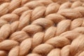 Merino wool handmade knitted large blanket, super chunky yarn, trendy concept. Close-up of knitted blanket, merino wool background Royalty Free Stock Photo