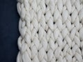 Merino wool handmade knitted large blanket, super chunky yarn, trendy concept. Close-up of knitted blanket, merino wool background Royalty Free Stock Photo