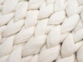 Merino wool handmade knitted large blanket, super chunky yarn, trendy cozy concept. Close-up of knitted blanket, merino wool backg Royalty Free Stock Photo