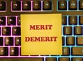 Merit, demerit and its retributions at the level of the individual. MERIT DEMERIT words on a yellow sticker on the background of a