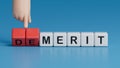 Merit or Demerit symbol. Concept word Merit or Demerit on wooden blocks. Businessman hand.Business and Merit or Demerit concept.