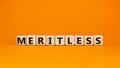 Meritless and merit symbol. The concept word Meritless on wooden cubes. Beautiful orange table, orange background. Business and Royalty Free Stock Photo