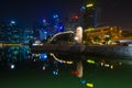 The Merlion fountain and Singapore skyline by night. Merlion is Royalty Free Stock Photo