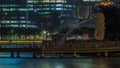 The Merlion fountain and Singapore skyline night to day timelapse. Royalty Free Stock Photo