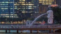 The Merlion fountain and Singapore skyline night to day timelapse. Royalty Free Stock Photo