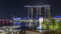 The Merlion fountain spouts water in front of the Marina Bay Sands hotel in Singapore timelapse hyperlapse.
