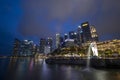 Merlion statue fountain in Merlion Park and Singapore city skyline at night Royalty Free Stock Photo