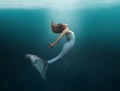 Mermaid in graceful swim undersea with sunlight shinning through the surface onto her beautiful face. Matte painting technique.