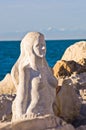 Mermaid sculpture carved out of the stone rocks at Piran harbor, Istria