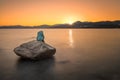Mermaid sculpture on rock in Ile Rousse Corsica at sunrise Royalty Free Stock Photo