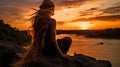 Mermaid silhouette sitting on a rock watching the sunset over the horizon. Blonde in a mermaid costume.