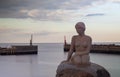 Mermaid statue on the coast of Asaa Docks, Denmark under a cloudy sky