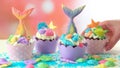 Mermaid theme cupcakes with colorful glitter tails, shells and sea creatures.