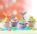 Mermaid theme cupcakes with colorful glitter tails, shells and sea creatures. Royalty Free Stock Photo