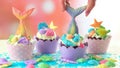 Mermaid theme cupcakes with colorful glitter tails, shells and sea creatures. Royalty Free Stock Photo