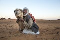 Man with his camel in a desert in Sudan Royalty Free Stock Photo
