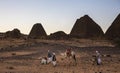 Men with their camels in a desert in Sudan