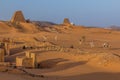 MEROE, SUDAN - MARCH 4, 2019: Locals on camels near Meroe pyramids, Sud