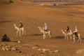 MEROE, SUDAN - MARCH 4, 2019: Locals riding camels near the pyramids of Meroe, Sud