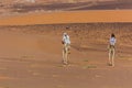 MEROE, SUDAN - MARCH 4, 2019: Locals riding camels near the pyramids of Meroe, Sud