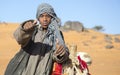 Sudanese young man with his camel in a desert