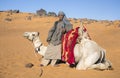 Sudanese young man with his camel in a desert