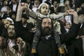 MERON,ISRAEL- MAY 26, 2016: An unidentified adorable Hasidic boy rejoices on his fathers' shoulders while wearing his fathers