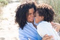 Merry African American mother and daughter on beach
