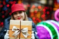 Merry blonde model with red lipstick wearing trendy cap and hold