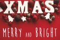 Merry and Bright Christmas text on Xmas wooden word with red ba