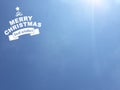 Merry Christimas message in white color on blue sky background