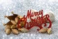 Merry christmas sign with crown and pinecone as christmas decoration Royalty Free Stock Photo