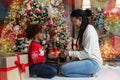 African american mother and daughter exchanging Christmas gifts