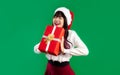 Merry Christmas, asian woman in christmas theme costume wearing santa hat holding red present box Royalty Free Stock Photo