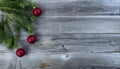 Merry Christmas background with real fir branch plus red ball ornaments on natural rustic wood Royalty Free Stock Photo