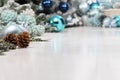 Merry christmas background, silver and blue christmas balls and pine cones decorations on white table, useful as a greeting card Royalty Free Stock Photo