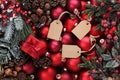 Merry christmas background, top view of composition with red balls , mistletoe, pine cone and tag label, useful as a greeting gift Royalty Free Stock Photo