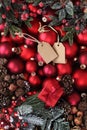 Merry christmas background, top view of composition with red balls , mistletoe, pine cone and tag label, useful as a greeting gift Royalty Free Stock Photo