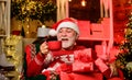 Merry christmas. Bearded senior man Santa Claus. Santa Claus relaxing in arm chair. Delivering gifts. Winter vacation Royalty Free Stock Photo