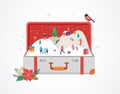 Merry Christmas, Big open suitcase with winter scene and small people, young men and women, families having fun in snow