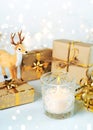 Merry Christmas. Christmas candle with reindeer,christmas gifts and christmas lights. Christmas concept background. Selective Royalty Free Stock Photo