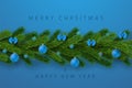 Merry Christmas card, blue background. Garland 3D border green branch, holiday elegant text invitation. Hanging decor