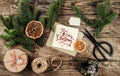 Merry Christmas card with fir branches, gifts on wooden background with scissors and skein of jute. Xmas and Happy New Year theme, Royalty Free Stock Photo