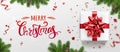 Merry Christmas card with holiday text, gift boxes, fir branches, red ribbons and bow, sparkles, bokeh on light background Royalty Free Stock Photo