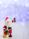 Merry christmas card with Santa Claus figurine. Lights background with space for text. Winter holidays Royalty Free Stock Photo