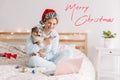 Merry Christmas card with text. Smiling woman in Santa hat with cute puppy dog pet calling family and friends on video call. Pet Royalty Free Stock Photo